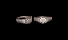 Roman Silver Ring with IVL
3rd century AD. A silver finger ring with D-section hoop, transverse ledges to the facetted shoulders, ellipsoid plaque wi...
