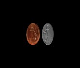 Roman Intaglio Gemstone with Sol Standing
2nd-4th century AD. A raised oval red carnelian intaglio gemstone engraved with the Roman god Sol standing ...
