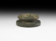 Roman Statuette Base
1st-2nd century AD. A bronze tiered statuette base of circular in form, with line detailing to the rims. 145 grams, 81.6mm (3 1/...
