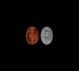 Roman Intaglio Gemstone with Standing Figure
2nd-4th century AD. An oval red carnelian intaglio gemstone engraved with a standing figure. 0.91 grams,...