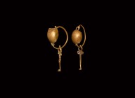 Roman Gold Earring Pair
2nd century AD. A pair of gold earrings with wire hoops and dome-shaped shield to the front; wire pendant threaded through lo...