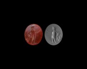 Roman Gemstone with Standing Figure
2nd-3rd century AD. A red carnelian intaglio engraved with a standing figure, facing right, wearing a radiate cro...