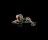 Roman Lion Hasp
1st-2nd century AD. A bronze hasp formed as a reclining lion with forelegs extended and head turned, herringbone pattern to the mane,...