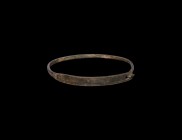 Roman Bracelet with Hooked Closure
1st-3rd century AD. A bronze bracelet comprising a flat-section shank with hook-and-eye closure, rilled edge and i...