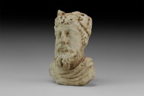 Roman Bust with Laurel Wreath
3rd-4th century AD. A carved marble bust of a male with laurel-leaf wreath, the a symbol of victory and honor; with sho...