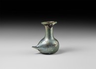 Roman Glass Spouted Feeding Bottle
4th-5th century AD. An iridescent blue glass spouted nursing bottle with bulbous body, pontil base, extruded spout...