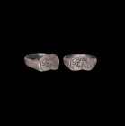 Roman Silver Ring with Beast
1st century AD. A silver ring comprising a flat hoop and D-shaped bezel, incised running wolf motif with pellets and 'LE...