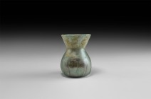 Roman Ribbed Glass Vessel
3rd-4th century AD. An aqua glass jar with globular body, vertical trails to the lower body, broad funicular mouth with rou...