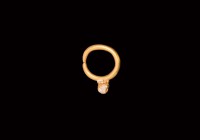 Roman Gold Ring with Turret
1st century AD. A round gold child's ring or possibly an earring, surmounted by faience filled turret with gold frame and...