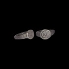 Byzantine Ring with AE Monogram
9th century AD. A silver ring with D-section hoop, round bezel with intaglio image of 'AE' monogram within a wreath. ...