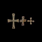 Byzantine Cross Mount Group
6th-9th century AD. A mixed group of three bronze cross mounts comprising: one pierced on each arm, large mounting lug be...