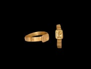 Byzantine Gold Ring with Bust
4th century AD. A gold ring comprising flat-section hoop with segmented outer face, square bezel with intaglio male bus...