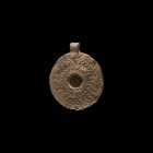 Byzantine Lead Mirror Pendant
7th-10th century AD. A lead mirror pendant with applied suspension loop, geometric design to the upper face, open centr...