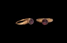 Byzantine Gold Ring with Garnet Turret
6th century AD. A gold ring comprising a hollow-formed hoop with coiled filigree to the upper and lower sectio...