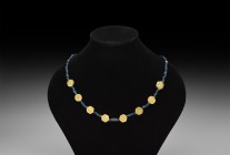 Byzantine Blue Glass Bead Necklace with Gold Elements
6th-8th century AD. A restrung necklace of blue glass drawn annular, biconvex and other beads w...