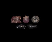Western Asiatic Amulet Group
1st millennium BC-1st millennium AD. A group of stone amulets comprising: a carved amethyst tortoise, pierced through th...