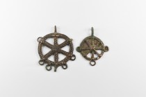 Western Asiatic Amlash Pendant Group
2nd millennium BC. A group of two bronze wheel pendants each with loops to the outer edge, suspension loop. 60 g...
