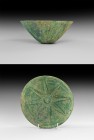 Western Asiatic Elamite 'Starburst' Bowl
3rd-2nd millennium BC. A bronze conical bowl with repoussé starburst detailing. See Aruz, J. Art of the Firs...