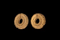 Western Asiatic Achaemenid Gold Earrings
5th-4th century BC. A matched pair of gold earrings, each a repoussé crescentic band with segmented edge, ba...