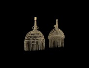 Western Asiatic Amlash Comb Pair
1st millennium BC. A mixed group of bronze combs comprising: a D-shaped openwork plate with tines to the lower edge,...