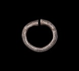 Western Asiatic Silver Bracelet with Animal Head Terminals
1st millennium BC. A hollow-formed silver hexagonal-section penannular bracelet with clubb...