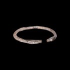 Western Asiatic Silver Bracelet with Animal Head Terminals
1st millennium BC. A round-section silver penannular bracelet with opposed beast-head term...