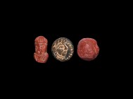 Western Asiatic Face Amulet Collection
1st millennium BC-1st millennium AD. A mixed group of amuletic human faces comprising: a schist disc with bead...