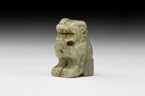 Chinese Carved Jade Lion
19th century AD. A carved jade figurine of a lion squatting, modelled in the round with gaping mouth and curled mane, suspen...