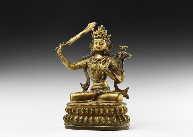 Tibetan Gilt Buddha Figure
20th century AD. A hollow-formed bronze figure of Bu...