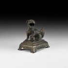 Chinese Qing Lion Statuette
Qing Dynasty, 1616-1911 AD. A hollow-formed bronze figure of a lion seated on a rectangular footed base, with one forepaw...
