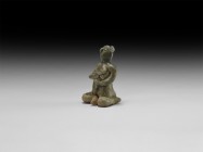 Thai Mother with Child Tukatha Statuette
12th century AD. A green-glazed ceramic figurine of a nude seated female suckling a baby in her arms; hollow...