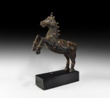 Chinese Rearing Horse Statue
19th-20th century AD. A carved wooden figure of a horse rearing with carved bridle, crupper and saddle, applied knops to...