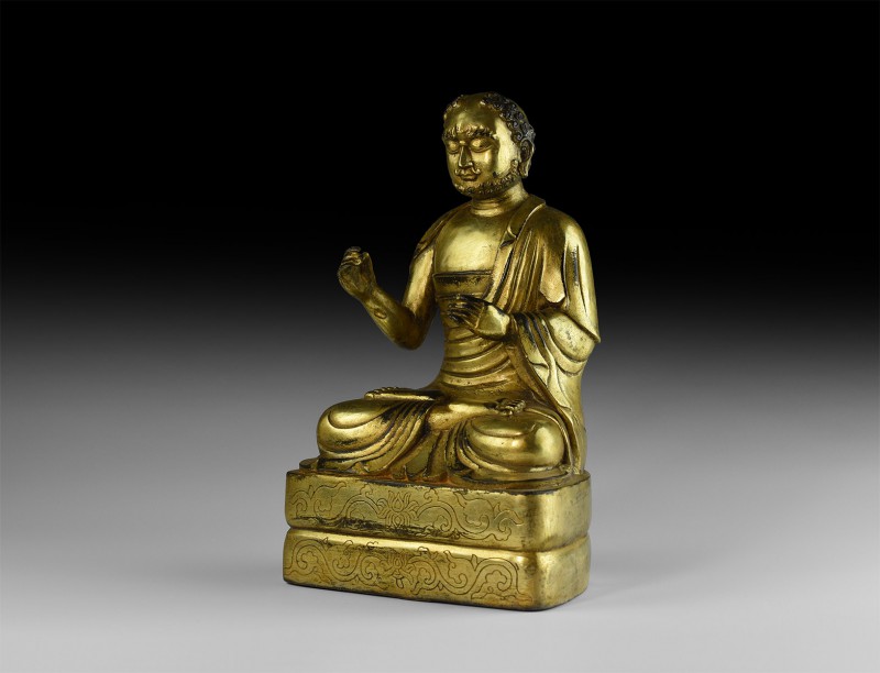 Tibetan Gilt Sitting Buddha Statuette
20th century AD. A hollow-formed gilt-bro...