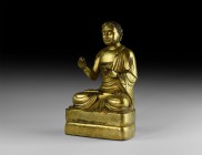 Tibetan Gilt Sitting Buddha Statuette
20th century AD. A hollow-formed gilt-bronze figure of Buddha sitting cross-legged on a gusseted base; Buddha d...