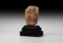 Gandharan Draped Terracotta Plaque
1st-4th century AD. A terracotta plaque with seated figure in a draped and pleated robe, hands drawn up to the che...