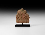 Gandharan Floral Terracotta Plaque
1st-4th century AD. A terracotta plaque comprising a flower with radiating petals and central bulb, lateral scroll...