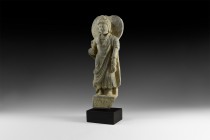 Gandharan Buddha Statuette
3rd-5th century AD. A carved schist statuette of Buddha with nimbus behind the head, draped mantle and collars, frieze of ...
