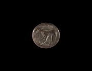 Indus Valley Stamp Seal with Antelope
3rd millennium BC. A bronze elliptical stamp seal with standing antelope, four dots in the field; loop handle t...