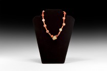 Indus Valley Etched Carnelian Bead Necklace
1st millennium BC. A restrung necklace of assorted oblate and fusiform carnelian beads, etched drum- and ...