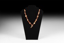 Indus Valley Etched Carnelian Bead Necklace
1st millennium BC or later. A restrung necklace of various shaped carnelian beads, interspersed with bico...