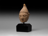 Indian Figurine Head with Cap
4th-6th AD. A gesso figurine head wearing a pointed Phrygian cap with peak pulled forward, clean shaven male face with ...