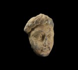 Gandharan Head Appliqué
1st-4th century AD. A carved schist facing mask of a male with tousled hair, large lentoid eyes, neat moustache above a small...
