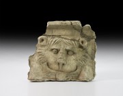 Gandharan Plaque with Lion's Head
1st-4th century AD. A gesso architectural panel with chamfered upper edge and ledge below, facing lion mask with cu...