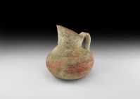 Large Indus Valley Water Jug
2nd millennium BC. A terracotta pitcher with squat bulbous body, dimple base, short neck with scooped rim, strap handle ...