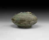 Islamic Calligraphic Lidded Bowl
11th-12th century AD. A broad bronze vessel formed as two shallow bowls, the lower with with arcade detailing and di...