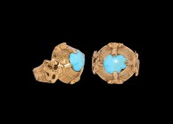 Seljuk Gold Ring with Turquoise
13th-14th century AD. A gold ring comprising a flat-section hoop with scroll detailing, applied plaques to the should...