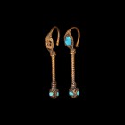 Islamic Ottoman Gold Earring Pair
14th-15th century AD. A matching pair of gold hoop earrings, applied lozenge-shaped plaque with inset turquoise and...