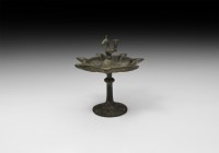 Islamic Oil Lamp with Bird
12th-13th century AD. A bronze oil lamp comprising a domed discoid base and tapering stem, with collar, dish with seven ra...
