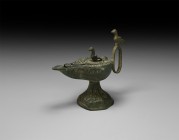 Islamic Oil Lamp with Birds
19th century AD. A bronze oil lamp in 12th-13th century style, comprising a facetted conical base, piriform body with nar...