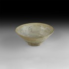 Islamic Glazed Bowl
10th-11th century AD. A tall white-glazed ceramic bowl with footed base, indented concentric circles to the inner wall and base. ...